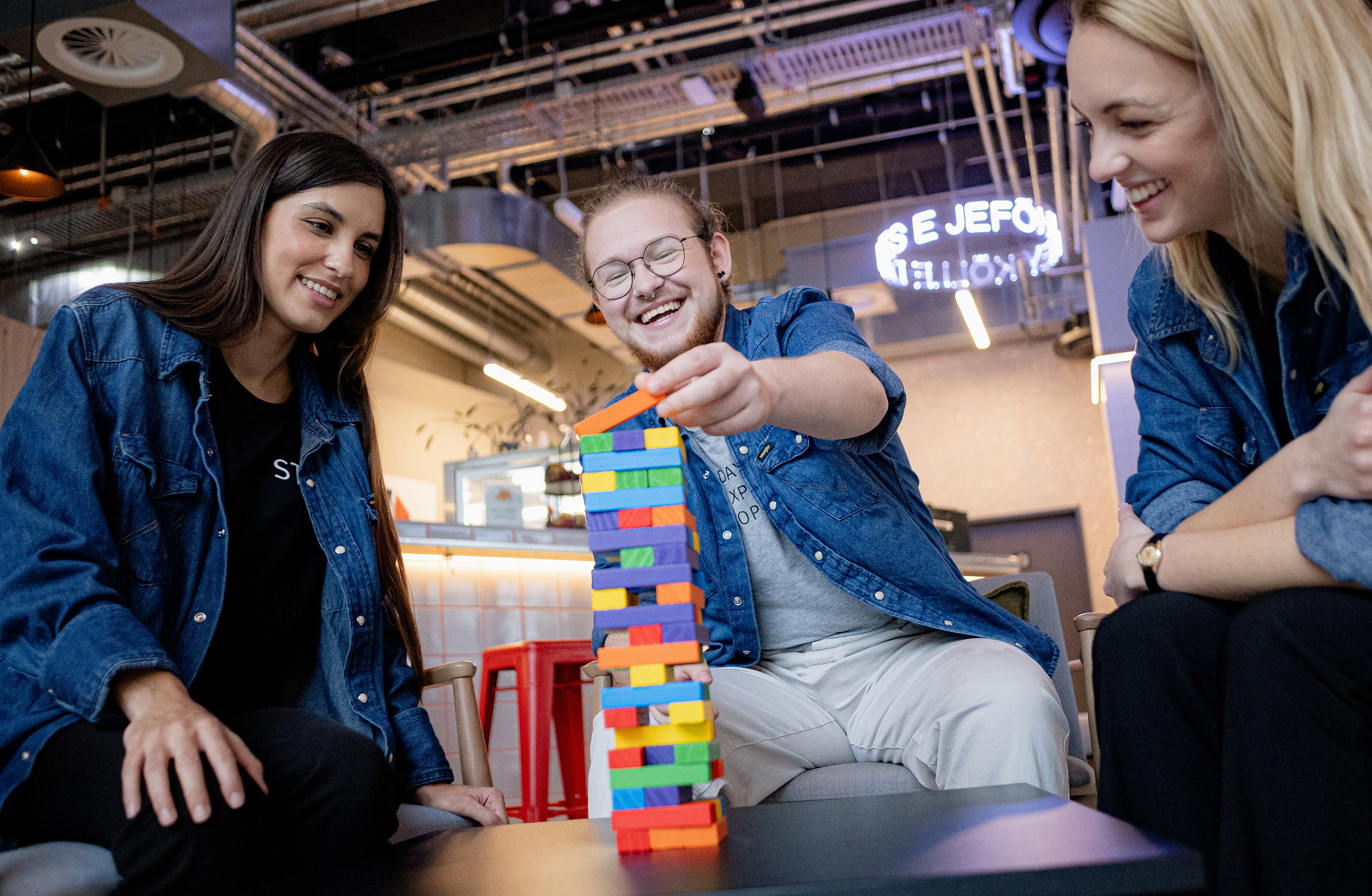 Giovani impiegati MEININGER che si divertono nel foyer di un Hotel MEININGER.