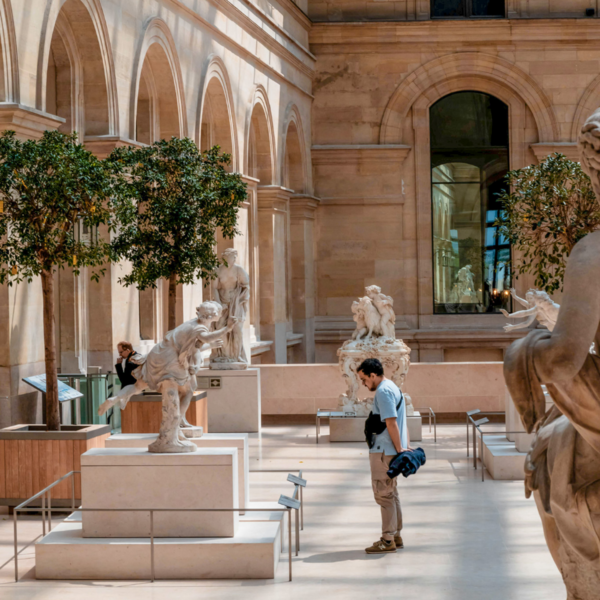 Visitatore ammira sculture al Museo del Louvre a Parigi